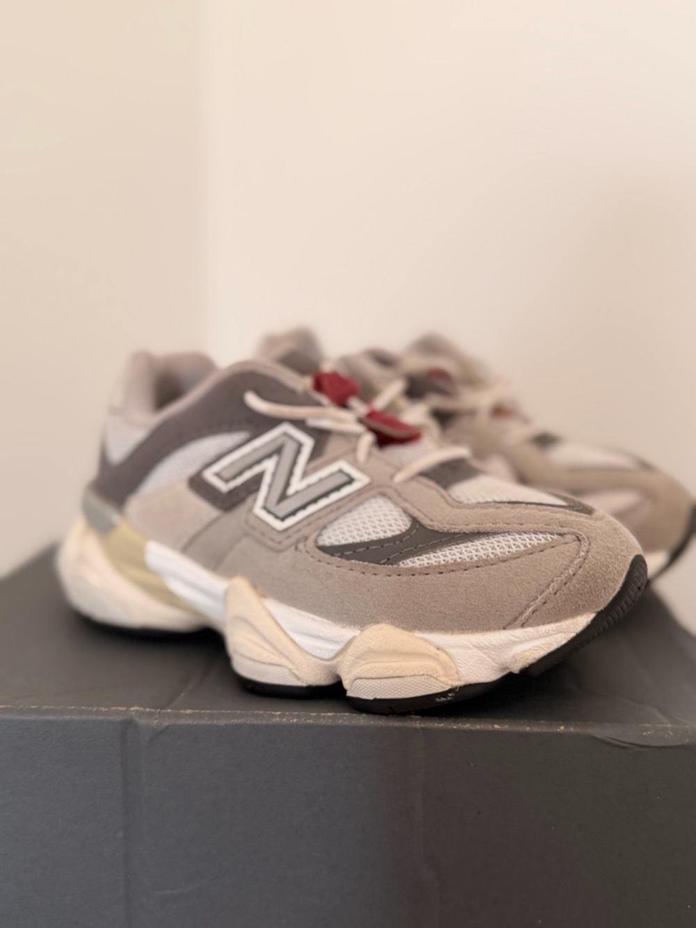 New Balance Kids Grey and White Sneakers with Red Lace Accent